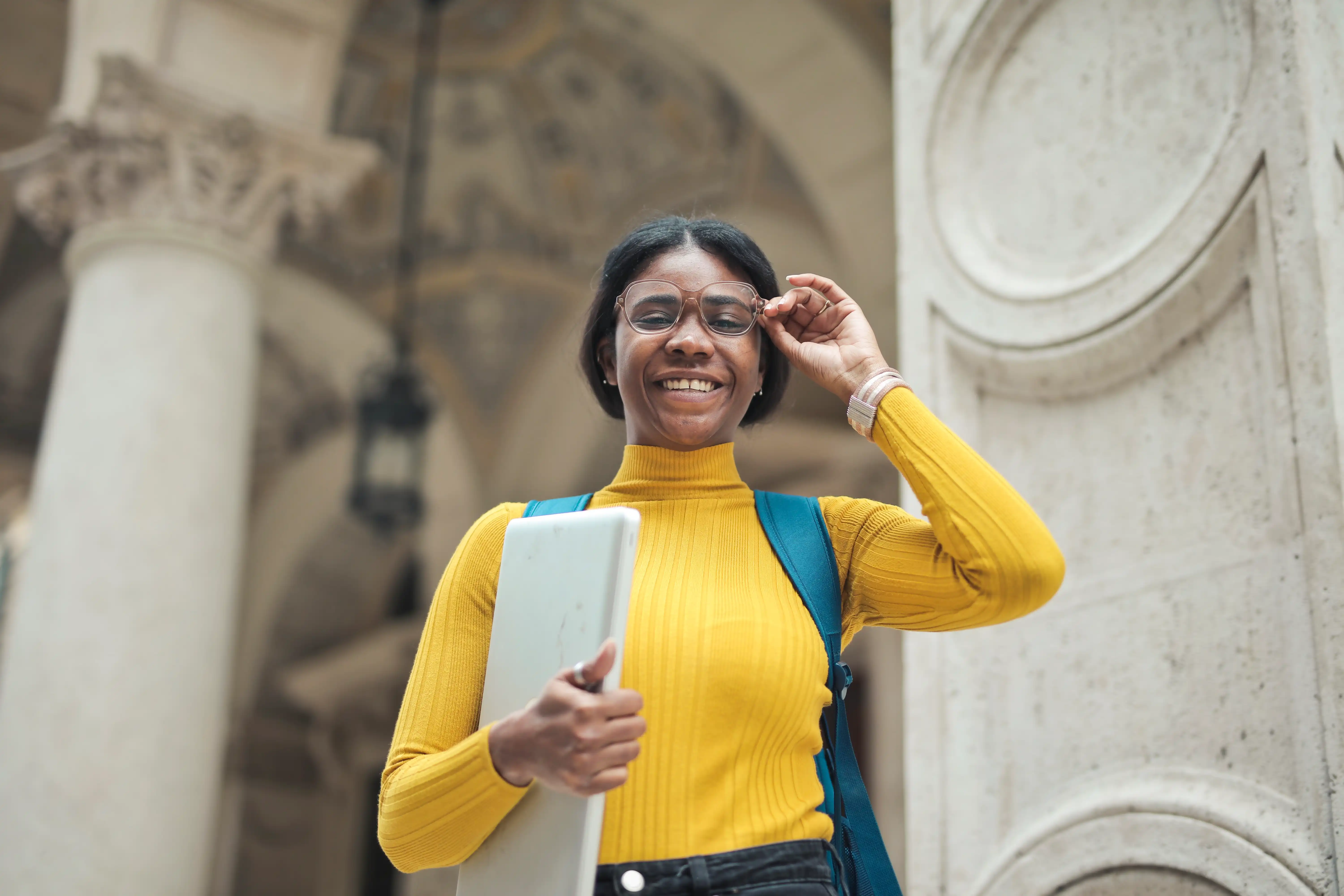 Student holding a computer on campus